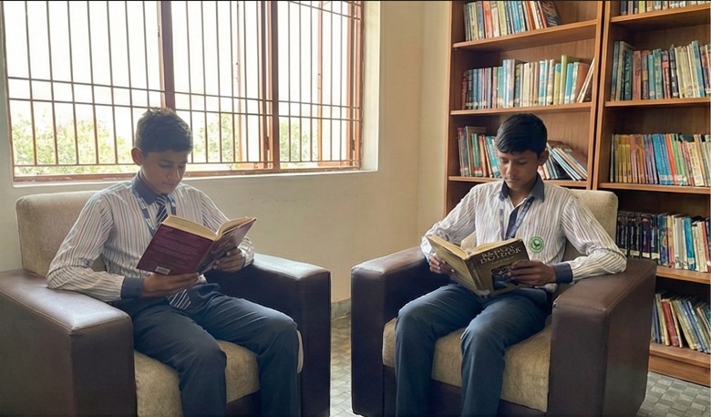 Wide view of a modern school library filled with bookshelves and study areas