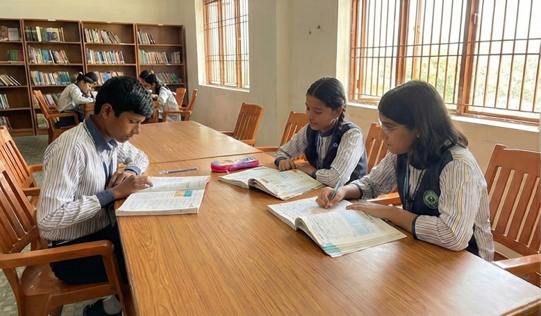 Students collaborating around a table in a designated group study zone